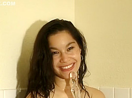 Barely legal brunette cutie smiles while teasing herself in the tub
