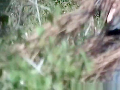 Blonde woman in shorts caught peeing in the nature