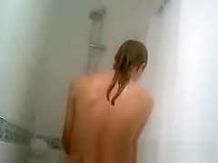 Blonde woman taking warm shower