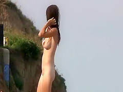 Brunette with big tits at nudist beach