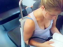 Busty teen 18+ girl reading in the train