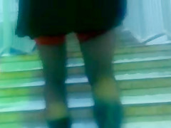 Chick flashing her black stockings with the red tops outdoor