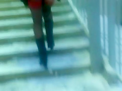 Chick flashing her black stockings with the red tops outdoor