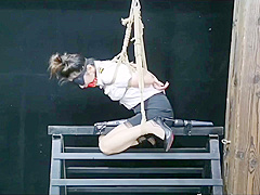 Chinese Model Sitting On A Iron Bar