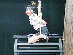 Chinese Model Sitting On A Iron Bar