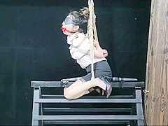 Chinese Model Sitting On A Iron Bar
