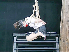 Chinese Model Sitting On A Iron Bar