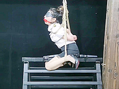 Chinese Model Sitting On A Iron Bar