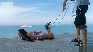 Chinese girl public bondage seaside