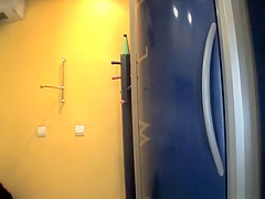 Chubby brunette undressing in tanning room