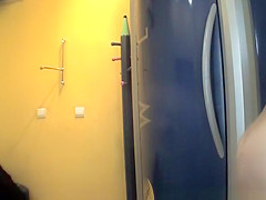 Chubby brunette undressing in tanning room