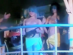 Club dolls dancing topless for the crowd