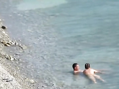 Couple fucked on a public beach while as people walked near