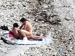 Couple fucked on a public beach while as people walked near