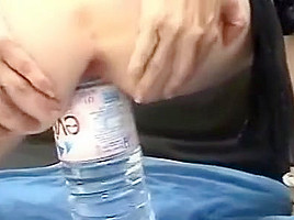 Evian bottle inserted in pussy