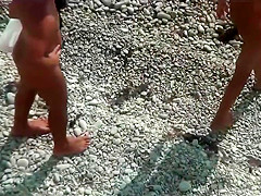 Girl with plug in the ass poses for a guy at public beach 2
