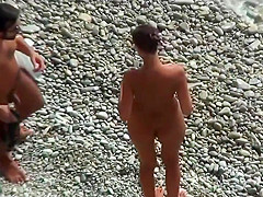 Girl with plug in the ass poses for a guy at public beach 2