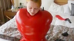 Inflatable red latex sack and gagged mouth