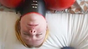 Inflatable red latex sack and gagged mouth