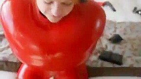 Inflatable red latex sack and gagged mouth