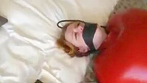 Inflatable red latex sack and gagged mouth