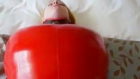Inflatable red latex sack and gagged mouth