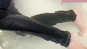 Jeans and barefoot underwater in the bathtub