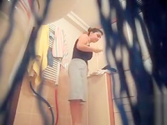 Large-breasted wife gets naked and takes a shower