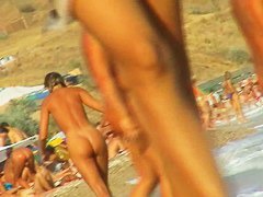Lush bodied MILF parades before a nude beach