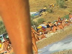 Lush bodied MILF parades before a nude beach