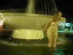 Naked night-time fountain play