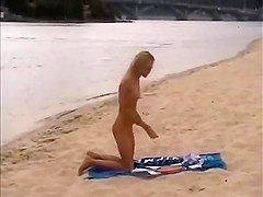 Nude girls outdoor on public beach having fun