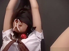 Oriental babe Blind folded ball gagged and kept in a cage