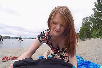 Outdoor POV with a redhead on the beach