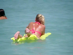 Pale buttocks in a pink thong bikini