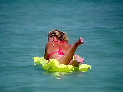 Pale buttocks in a pink thong bikini