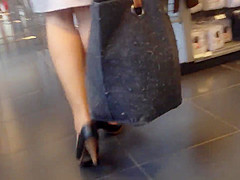 Sexy blonde milf in a store