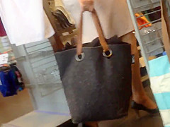 Sexy blonde milf in a store