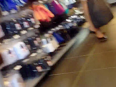 Sexy blonde milf in a store