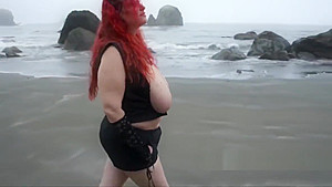 Shocking red hair and big tits on the beach
