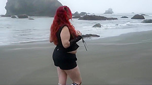 Shocking red hair and big tits on the beach