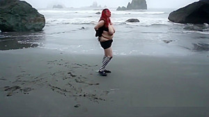 Shocking red hair and big tits on the beach