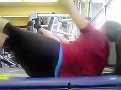 Sporty ass brunette works out in the gym