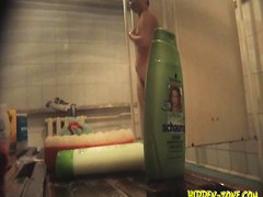 Spying real slim beauty shaving in a public shower