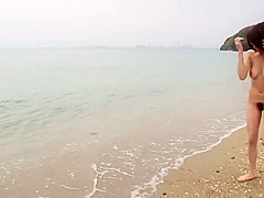 Sweet Japanese brunette goes skinny dipping at the beach