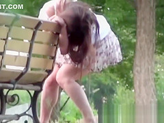 Tantalizing Japanese in skirt peeing behind bench in park