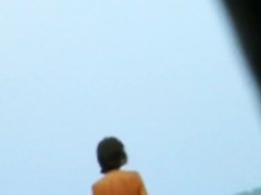 Topless sleek hotties on the nude beach getting filmed by a
