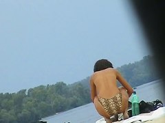 Topless sleek hotties on the nude beach getting filmed by a