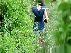 Woman in jeans shorts taking a pee