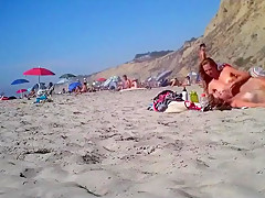 2 girls make fun with a guy's microdick on a nudist beach